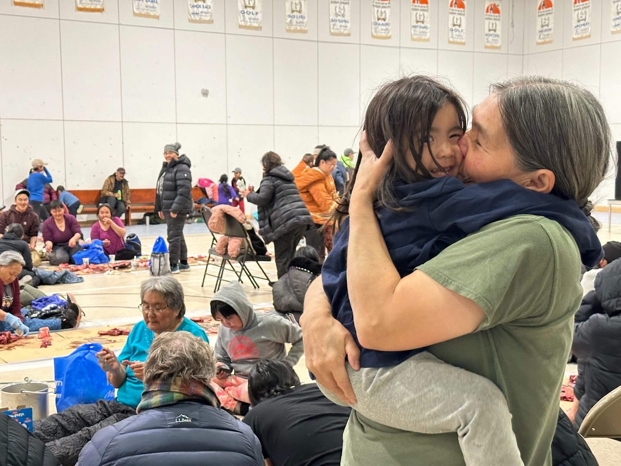 Woman kissing her child at a community event