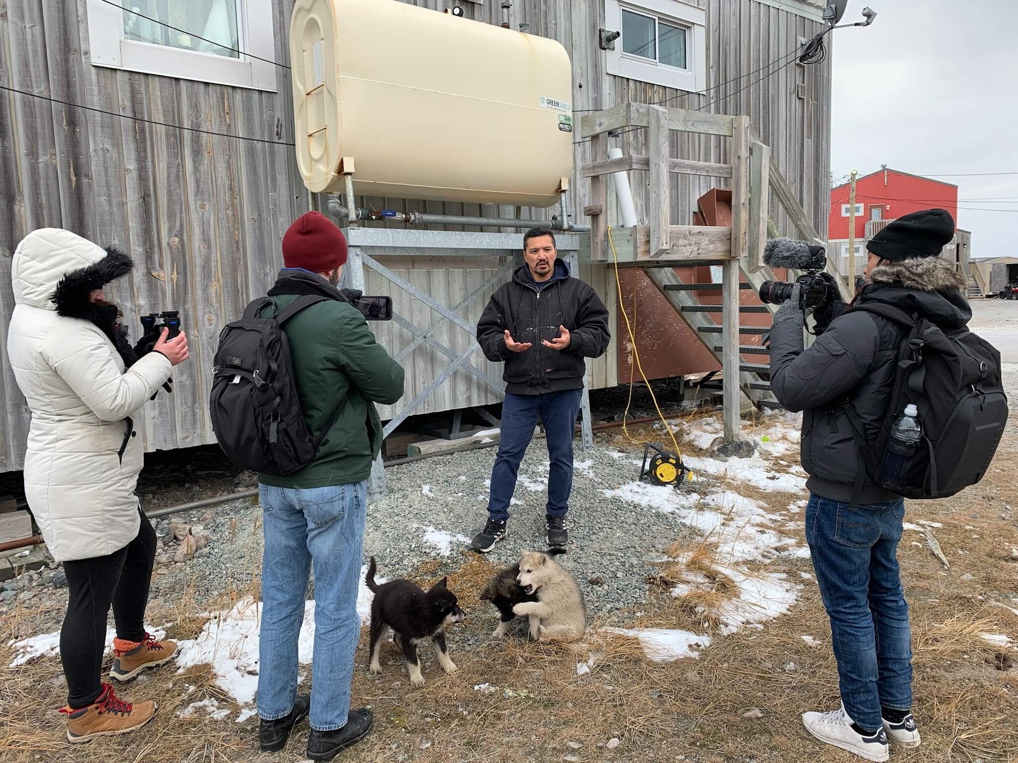 Team of journalists conducting and recording an interview