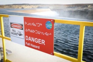 A danger sign marks the entrance of the Innavik Hydro facility in Inukjuak, Quebec, on a crisp and windy day in October 2024.